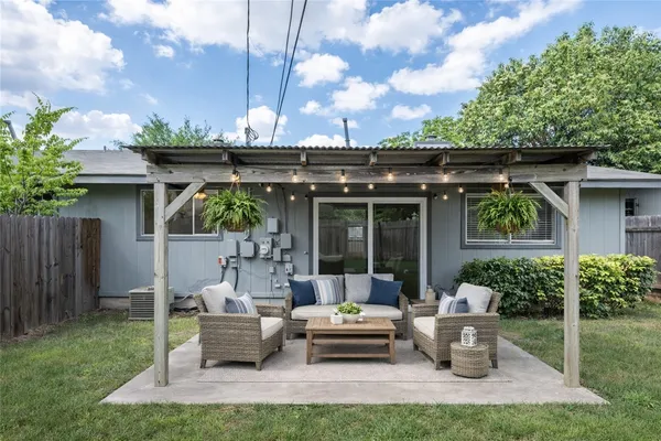 a view of a house with patio in the backyard