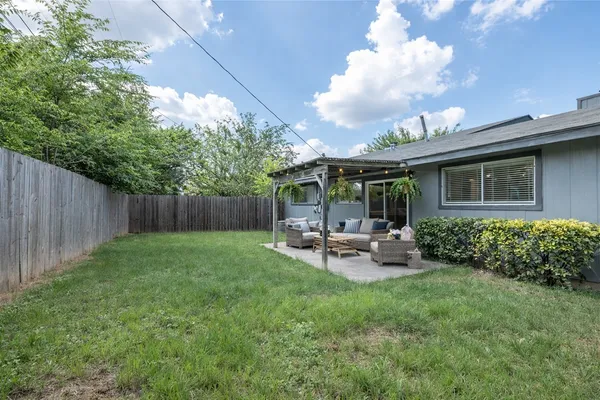 a view of a house with backyard sitting area and garden