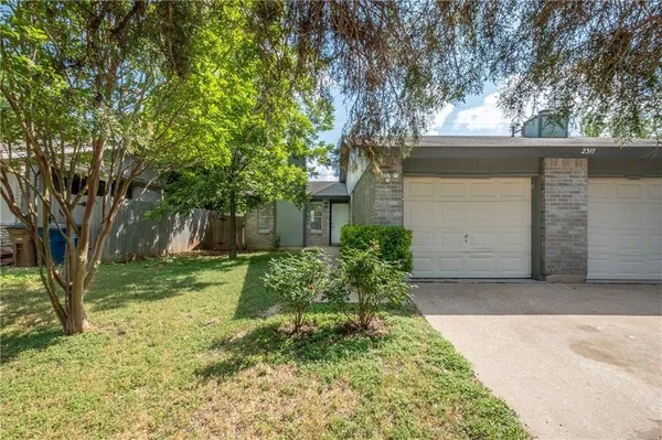 front view of a house with a yard
