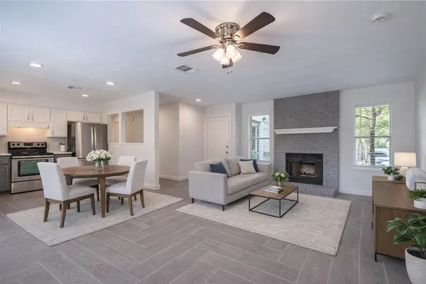 a living room with furniture fireplace and dining room