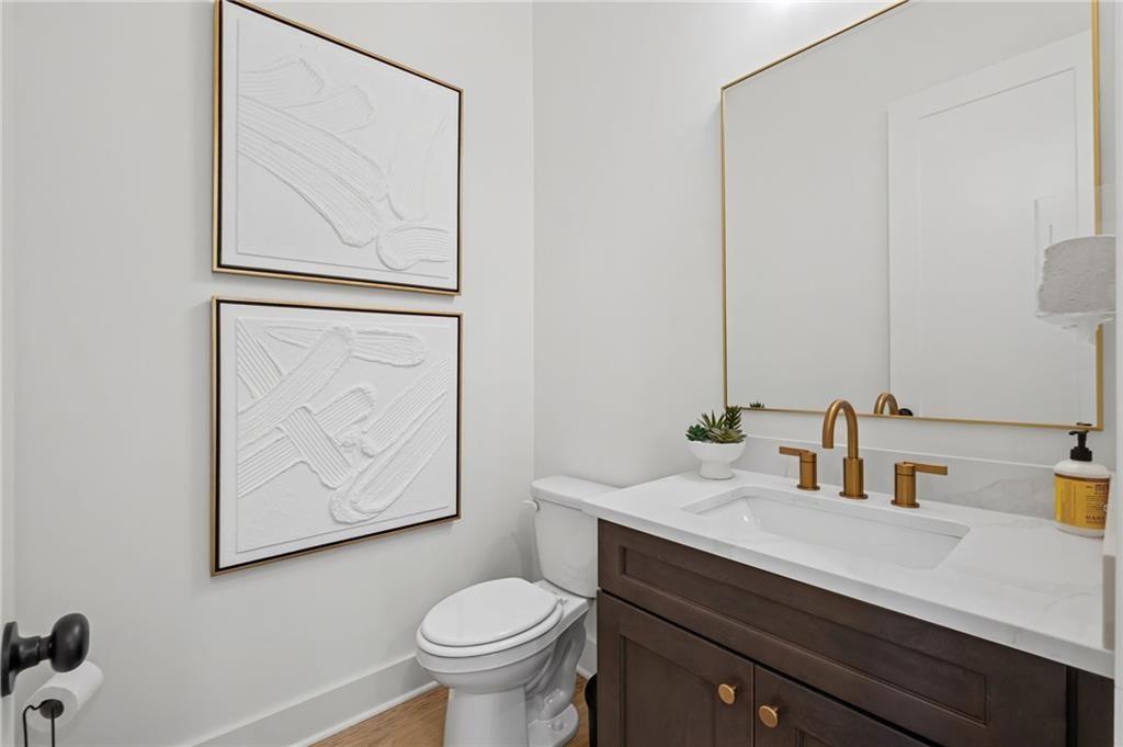 3440 Commander Cove Suwanee, GA 30024 - Photo 18 of 49 a bathroom with a sink mirror vanity and toilet