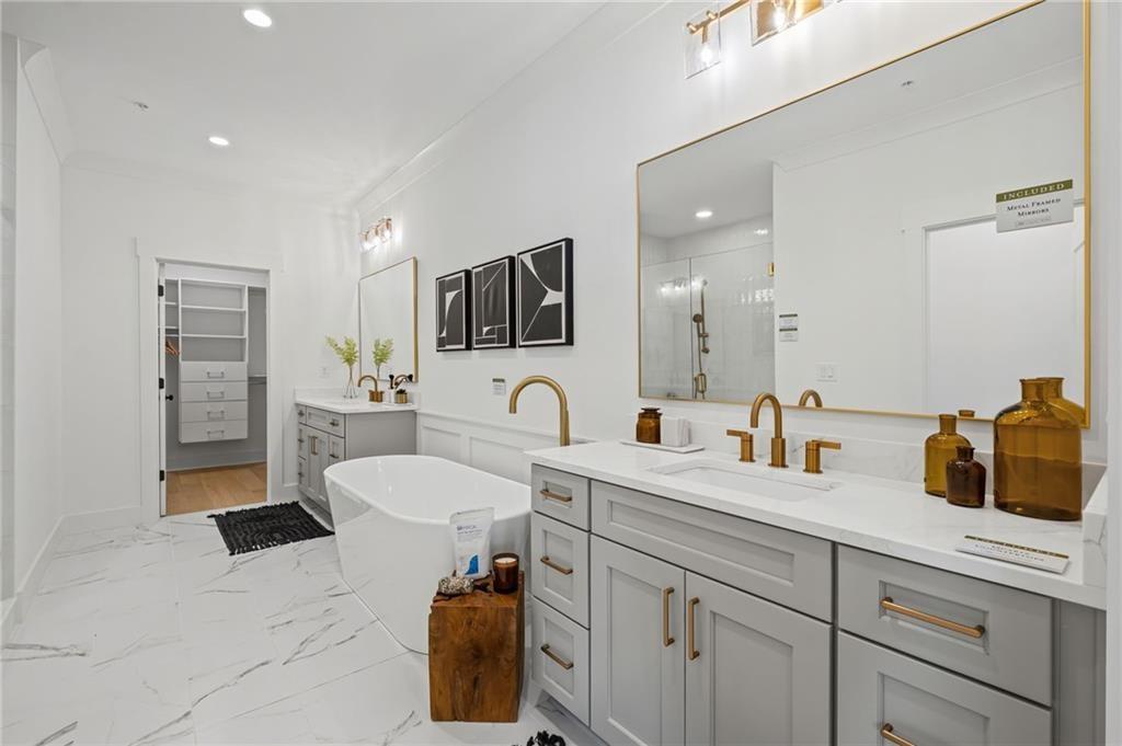 3440 Commander Cove Suwanee, GA 30024 - Photo 22 of 49 a spacious bathroom with a sink double vanity granite and a mirror