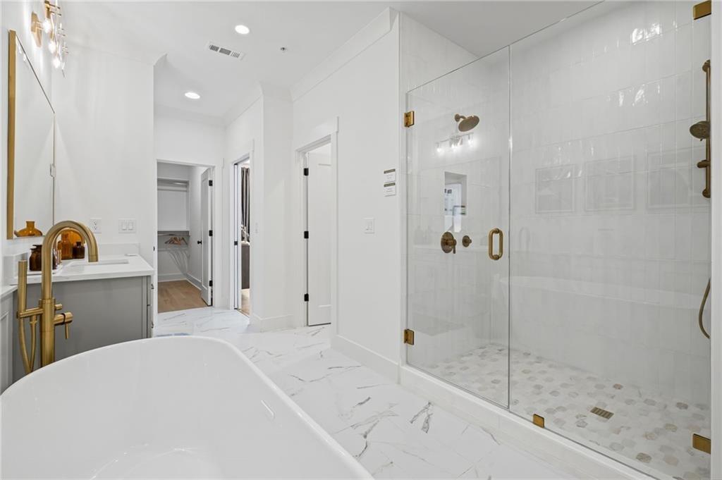 3440 Commander Cove Suwanee, GA 30024 - Photo 23 of 49 a bathroom with a bathtub and a shower