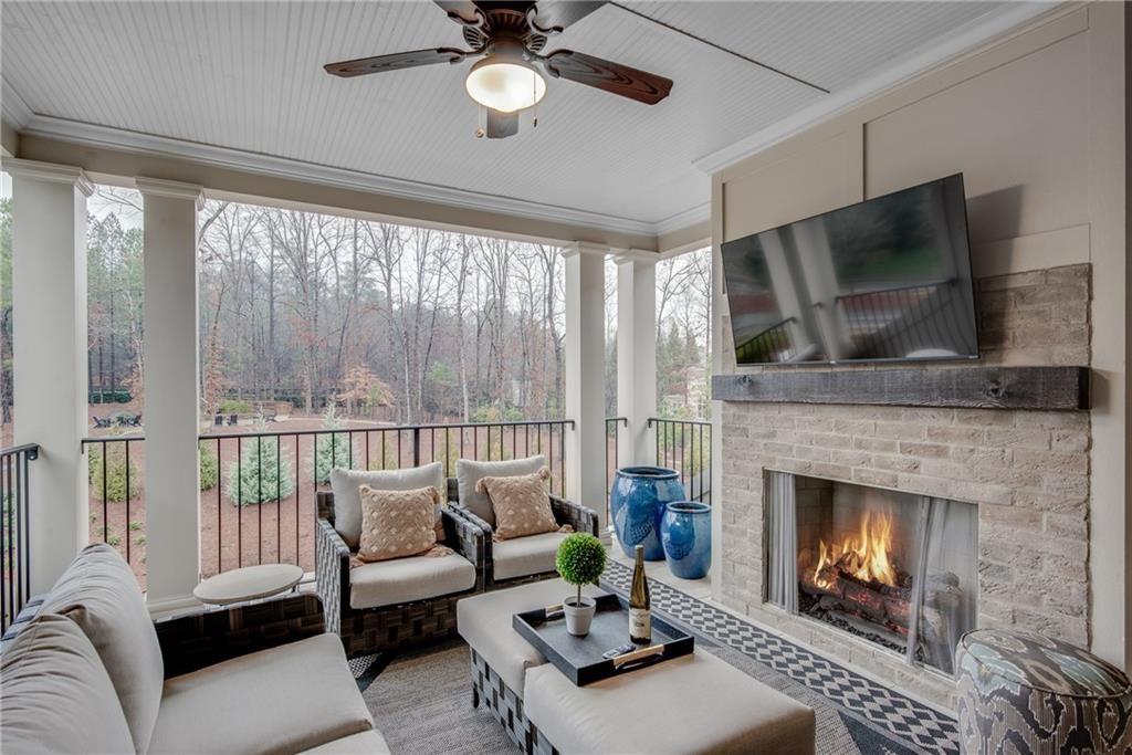 3440 Commander Cove Suwanee, GA 30024 - Photo 38 of 49 a living room with furniture a fireplace and a flat screen tv