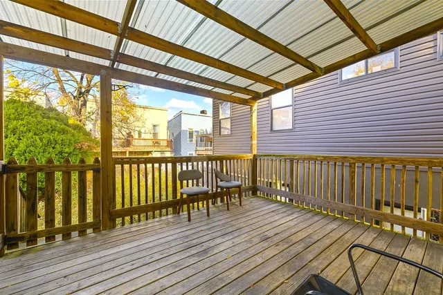 a view of a balcony with wooden floor