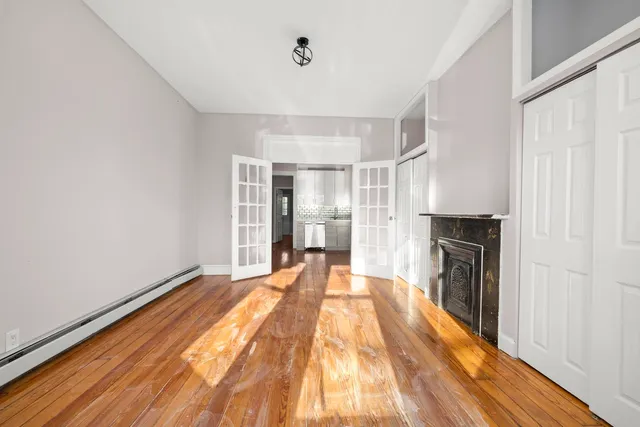 a view of a living room with a fireplace