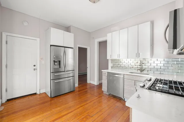 a kitchen with stainless steel appliances a refrigerator sink and stove