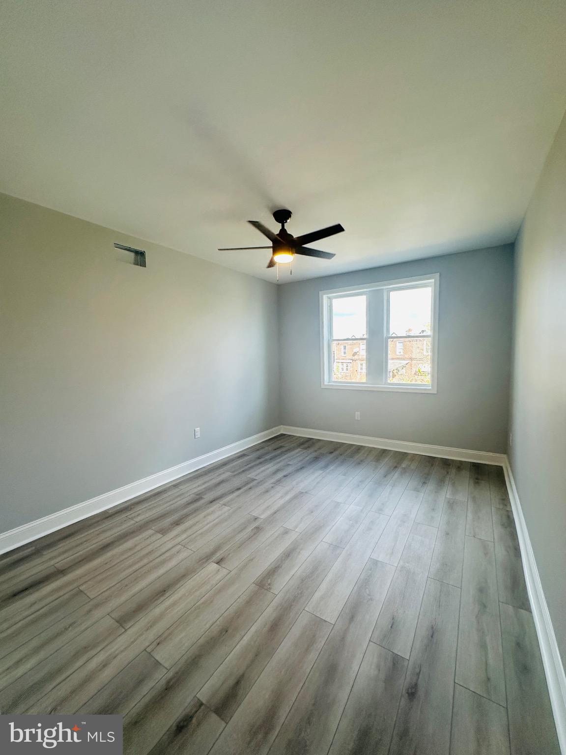 3451 Cottman Avenue Philadelphia, PA 19149 - Photo 11 of 18 an empty room with wooden floor and windows