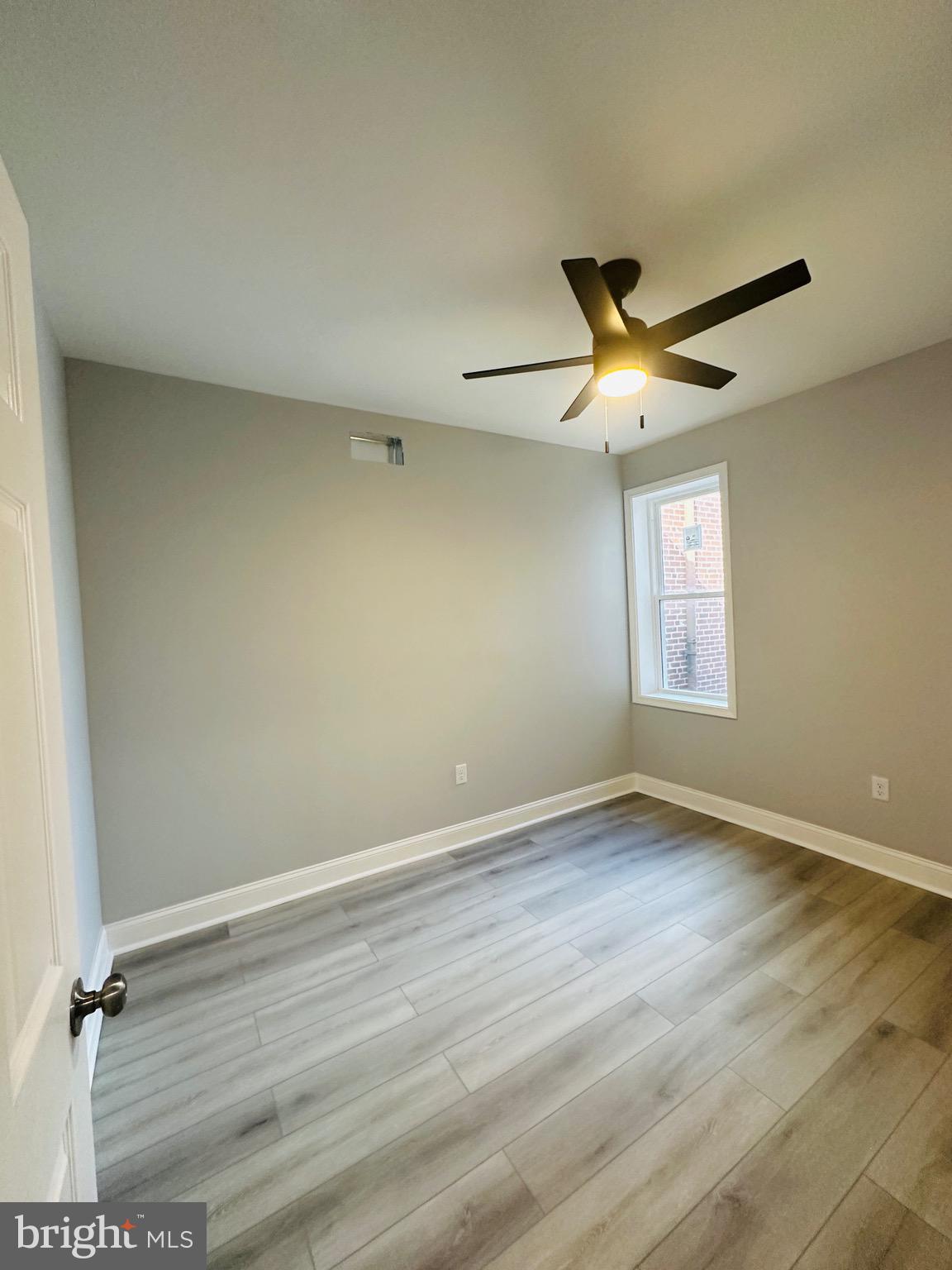 3451 Cottman Avenue Philadelphia, PA 19149 - Photo 14 of 18 an empty room with wooden floor and windows