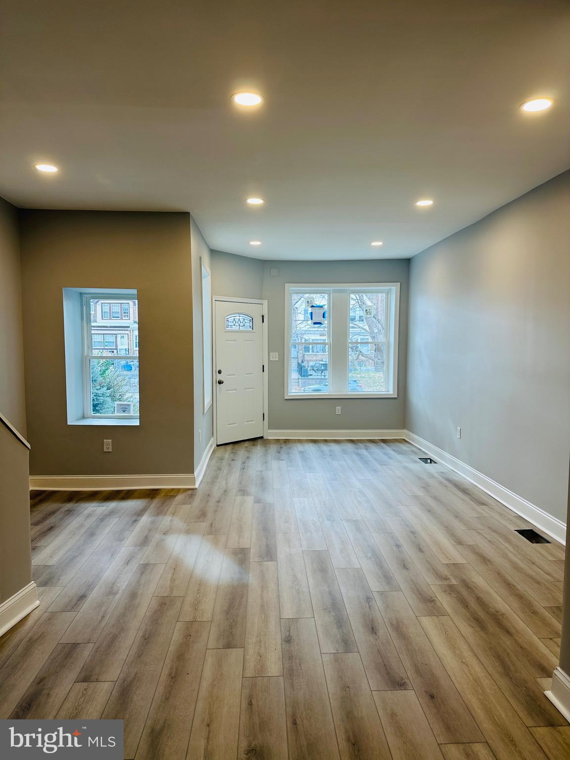3451 Cottman Avenue Philadelphia, PA 19149 - Photo 3 of 18 an empty room with wooden floor and windows