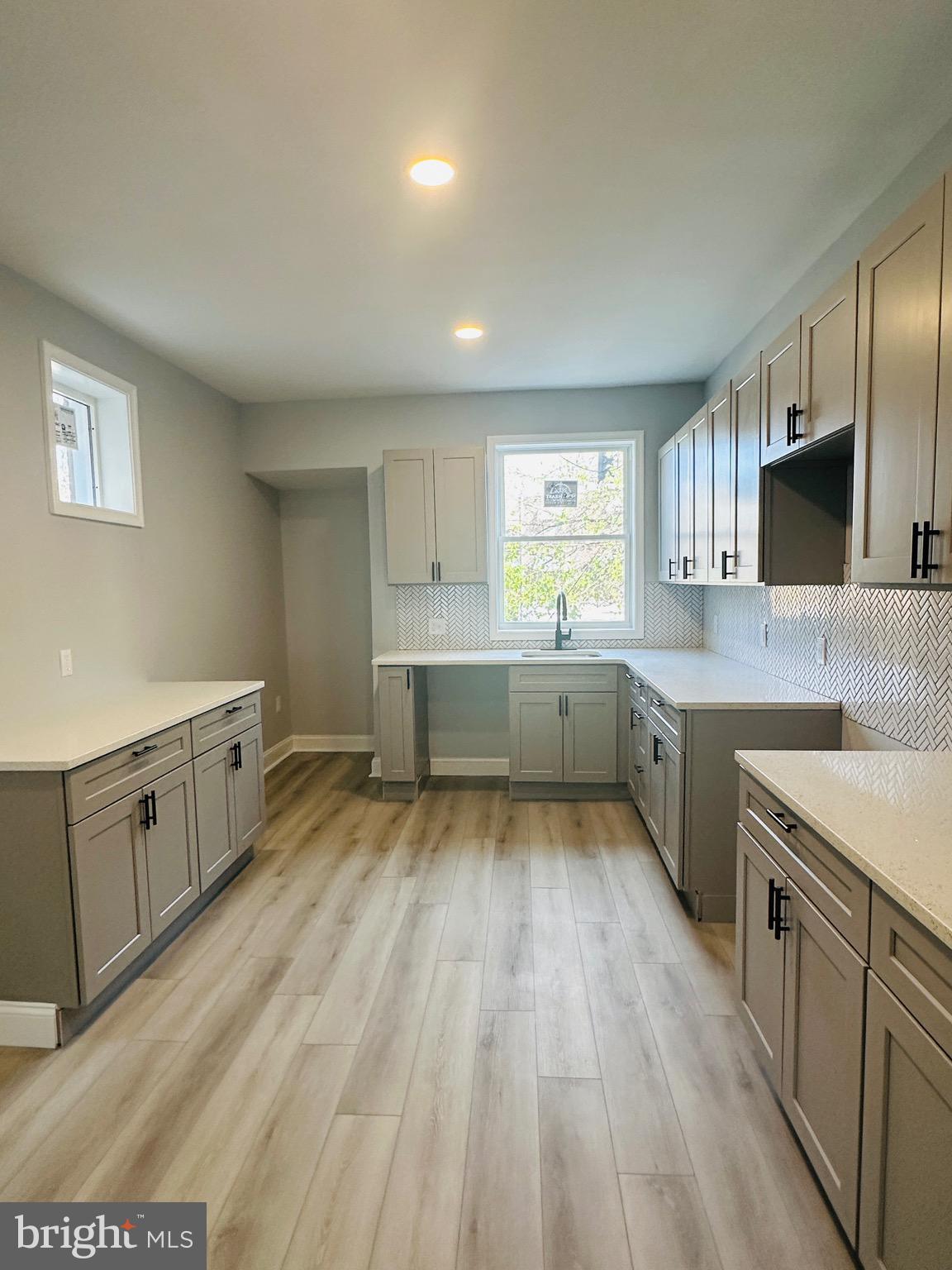 3451 Cottman Avenue Philadelphia, PA 19149 - Photo 6 of 18 a large kitchen with a stove sink and cabinets