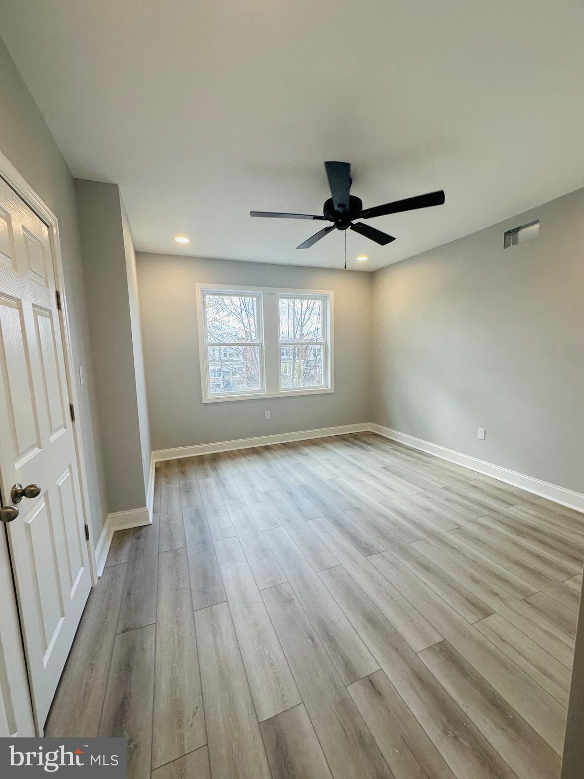 3451 Cottman Avenue Philadelphia, PA 19149 - Photo 9 of 18 an empty room with wooden floor and windows