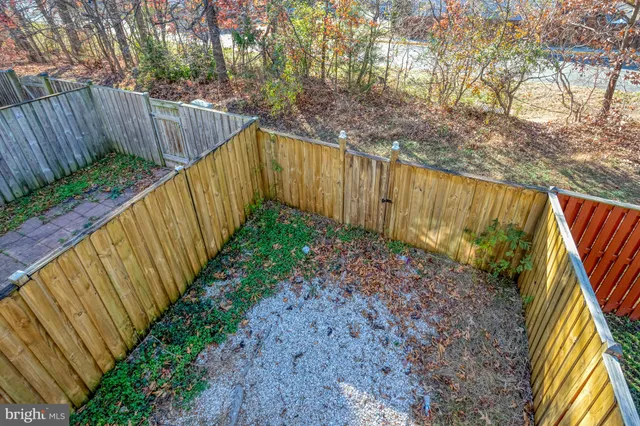 a backyard of a house with lots of green space and outdoor seating