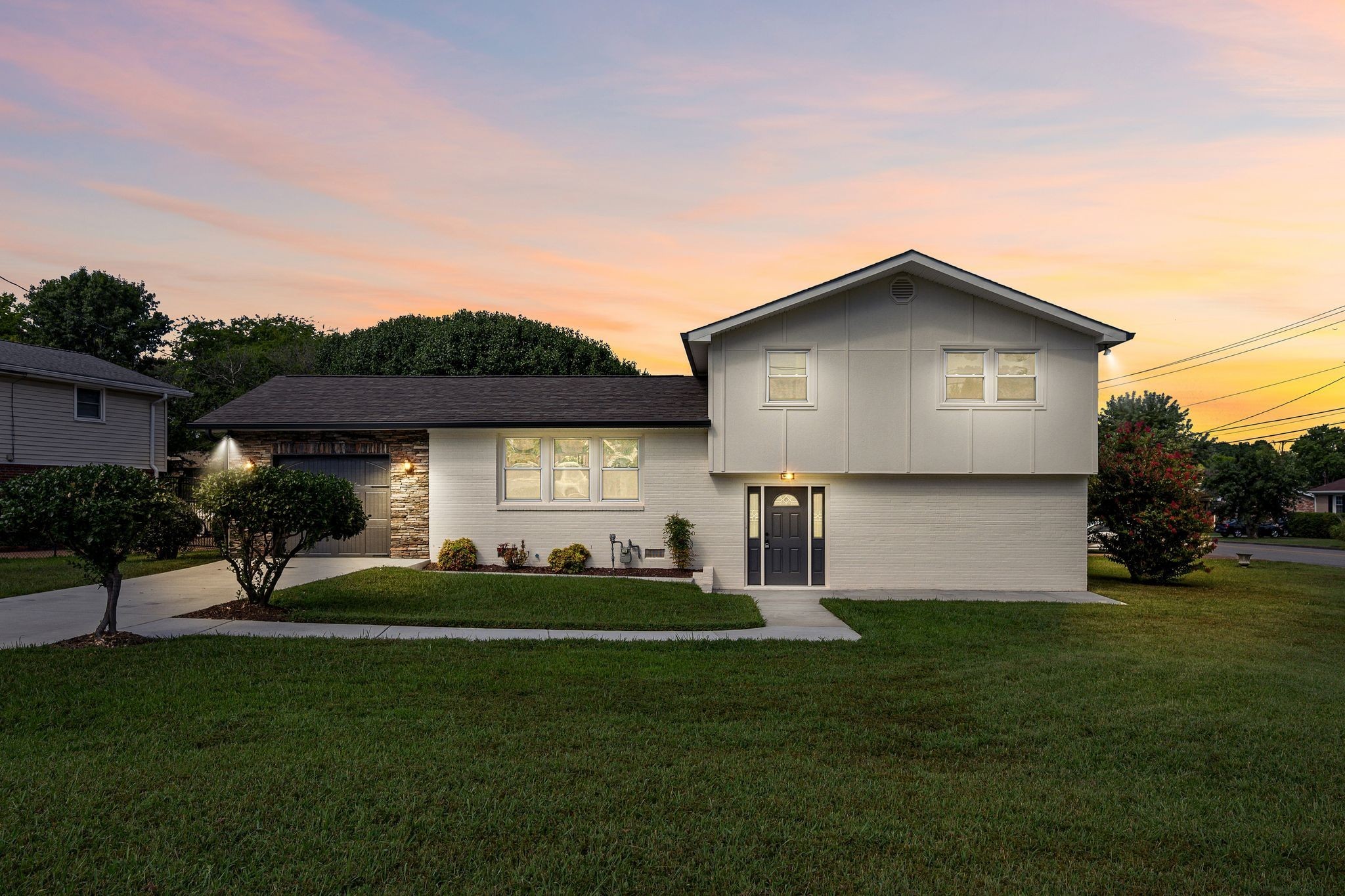 a front view of house with yard and green space
