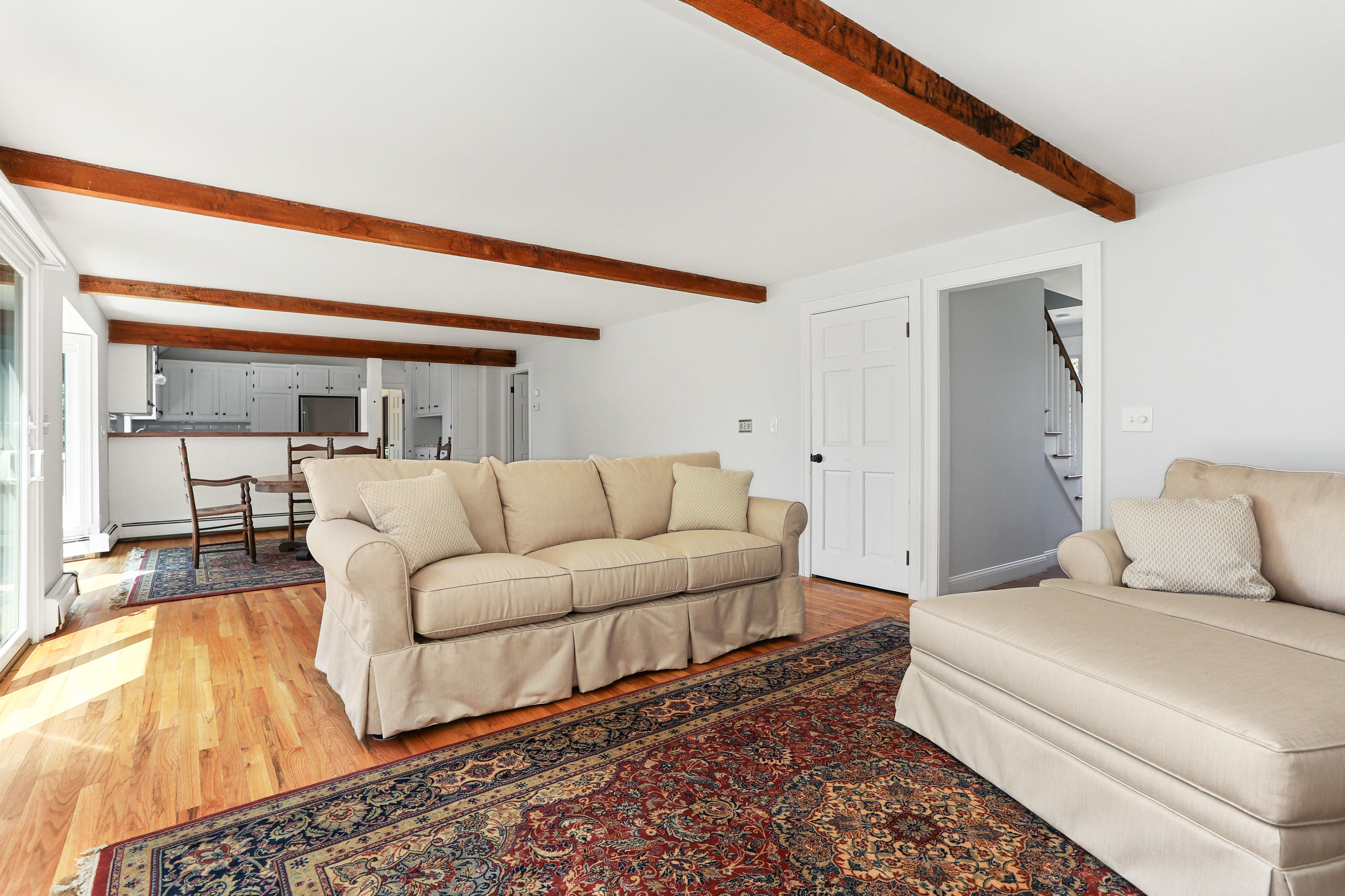 225 Goody Hallet Drive Eastham, MA 02642 - Photo 11 of 45 a living room with furniture and a large window