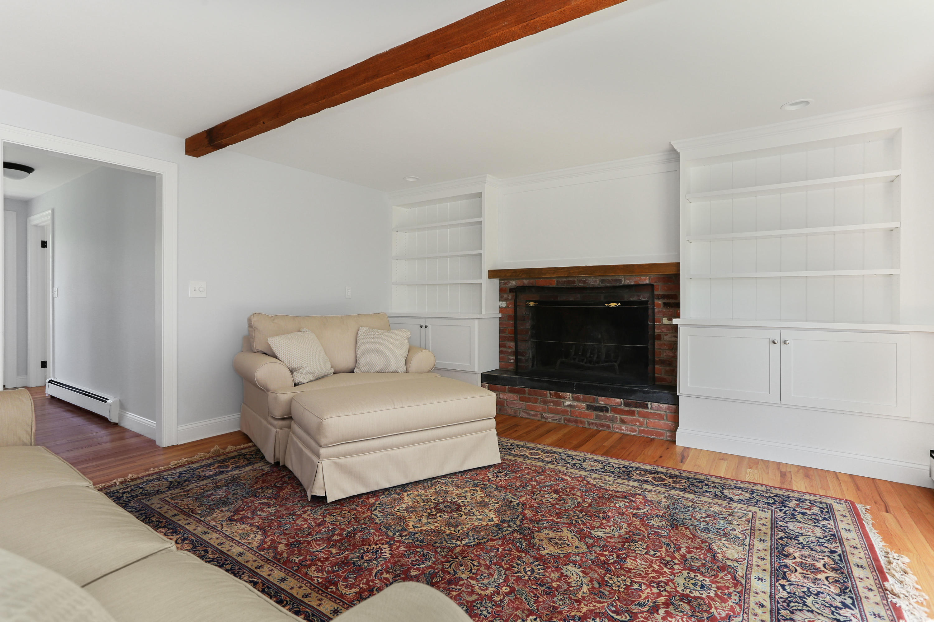 225 Goody Hallet Drive Eastham, MA 02642 - Photo 13 of 45 a living room with a couch and a fireplace