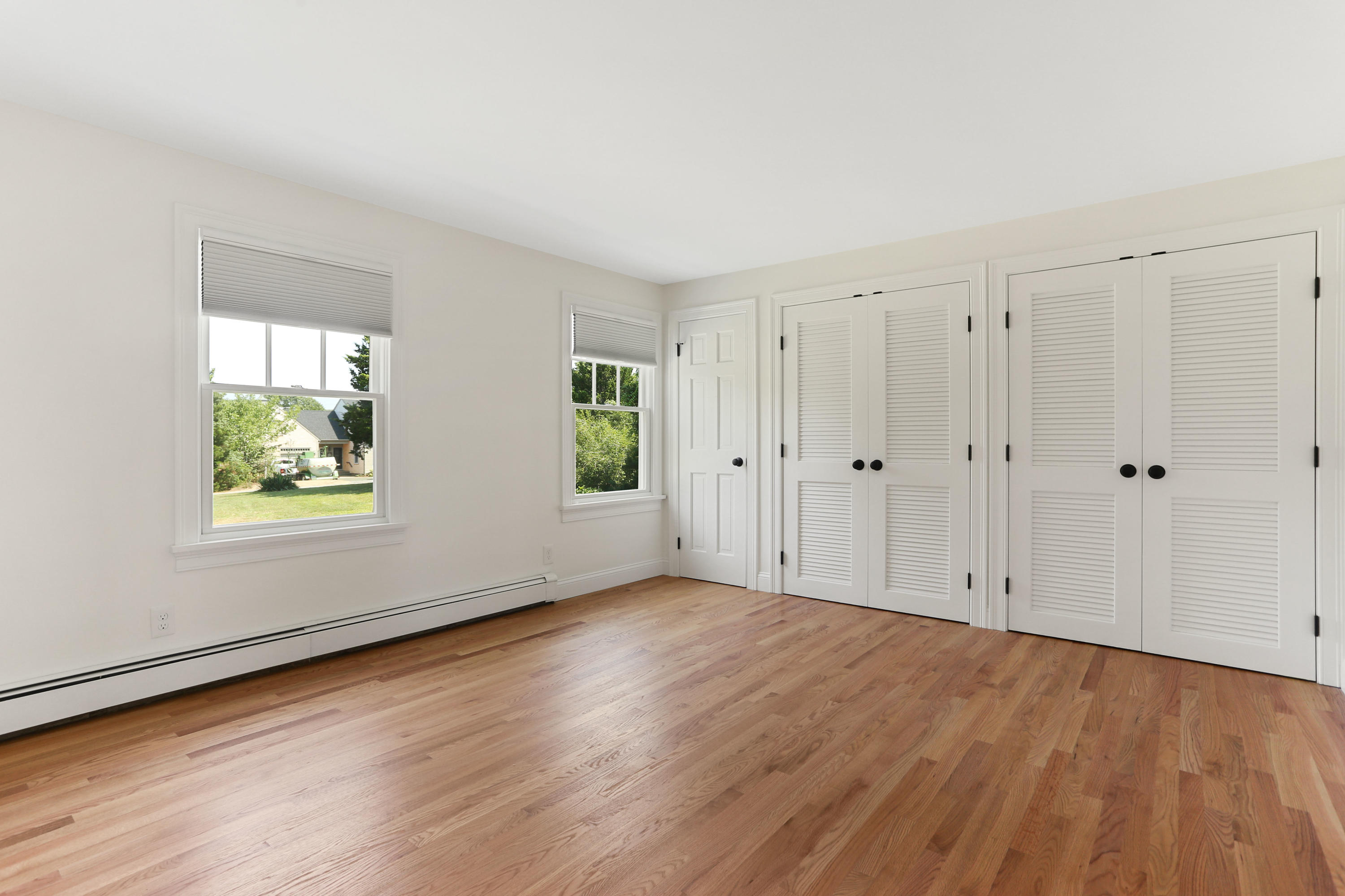 225 Goody Hallet Drive Eastham, MA 02642 - Photo 15 of 45 a view of an empty room with wooden floor and a window
