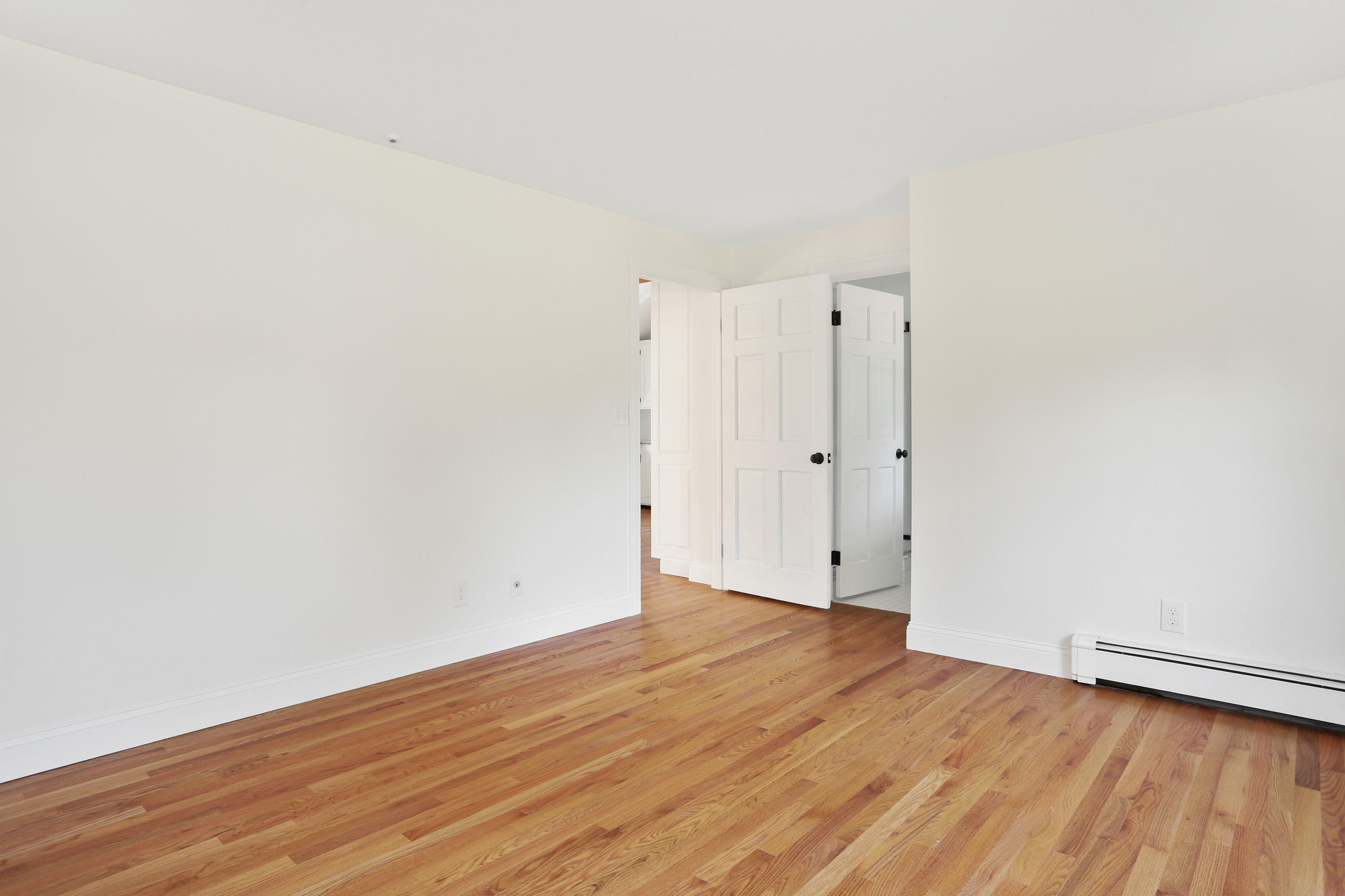 225 Goody Hallet Drive Eastham, MA 02642 - Photo 16 of 45 an empty room with wooden floor