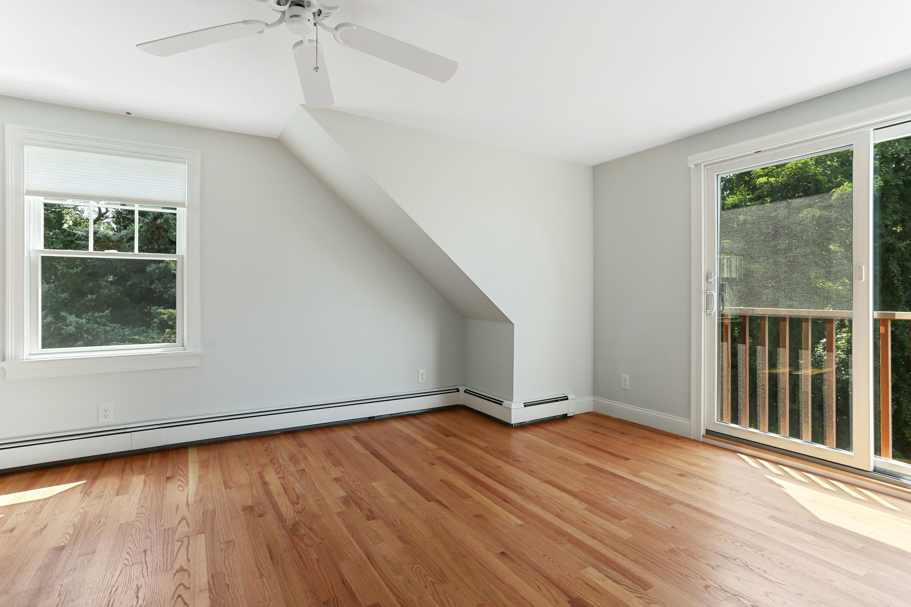 225 Goody Hallet Drive Eastham, MA 02642 - Photo 22 of 45 an empty room with wooden floor and windows
