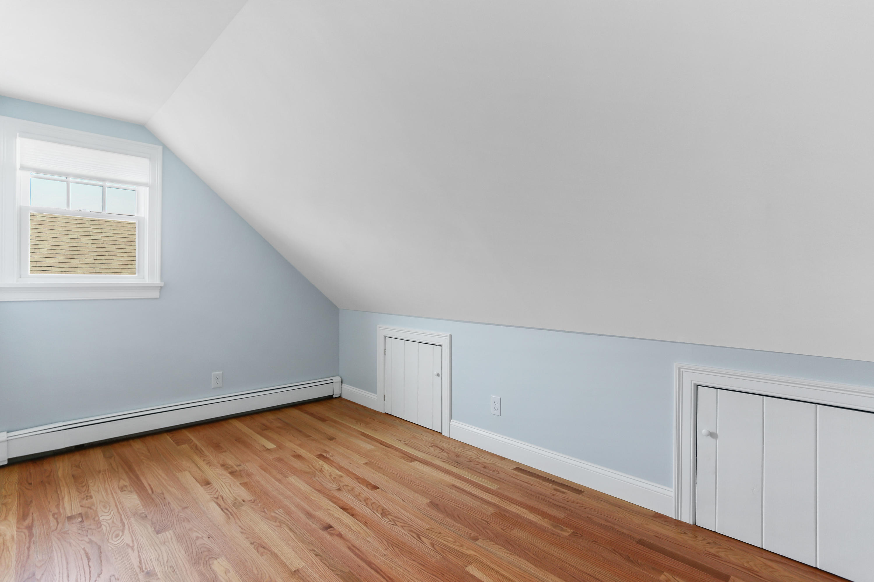 225 Goody Hallet Drive Eastham, MA 02642 - Photo 27 of 45 an empty room with wooden floor and windows