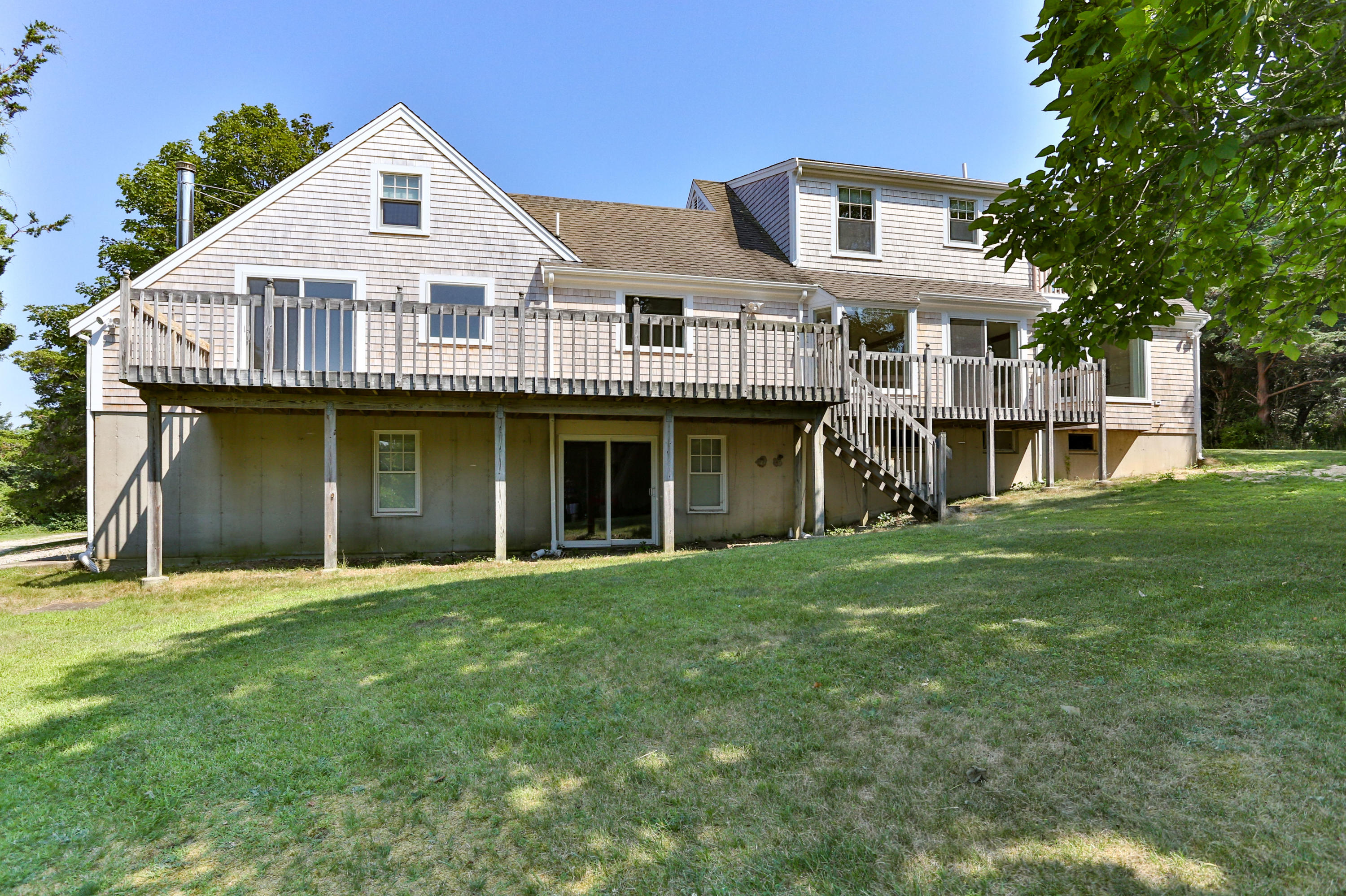 225 Goody Hallet Drive Eastham, MA 02642 - Photo 33 of 45 a front view of a house with a yard and balcony