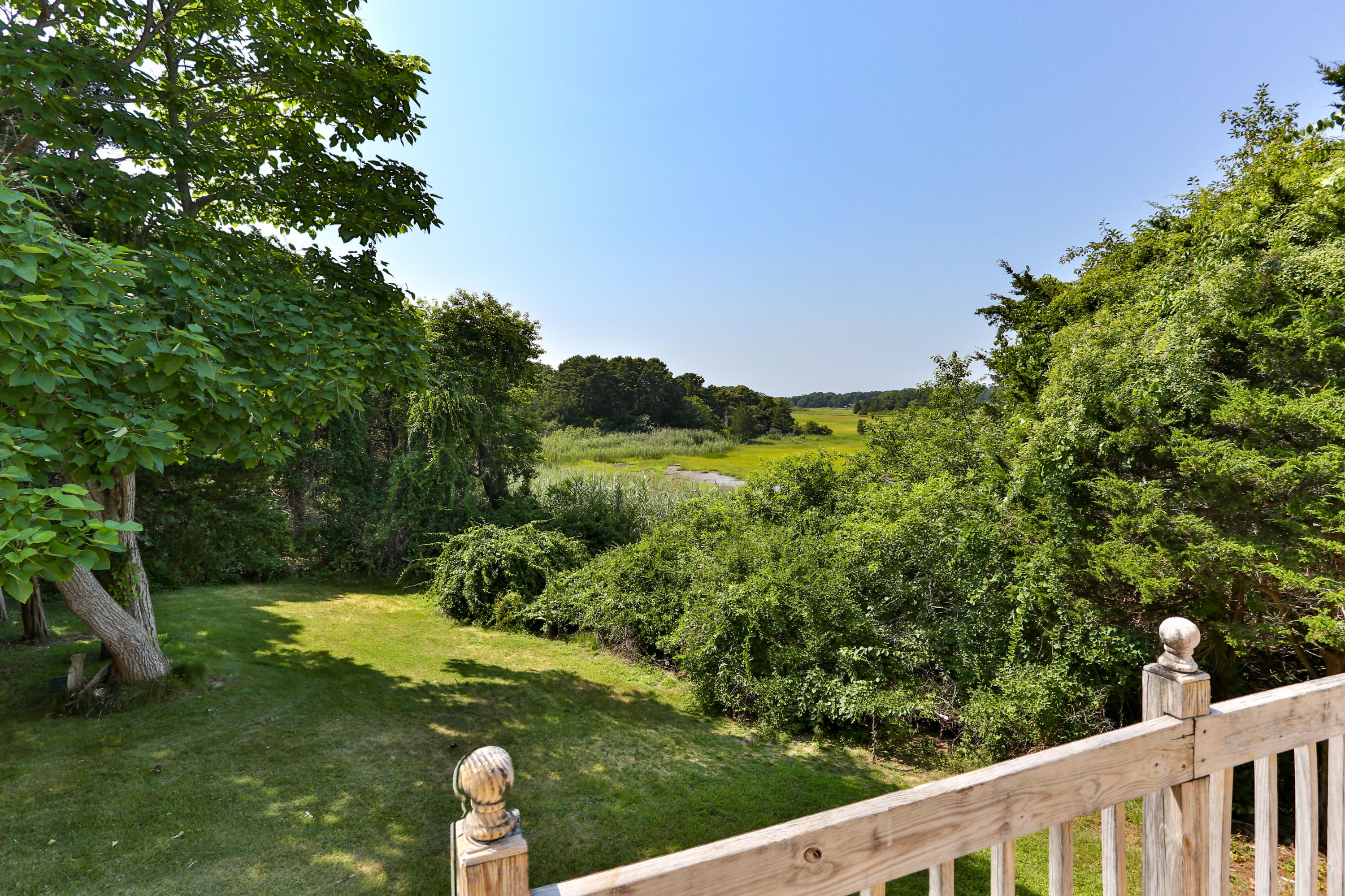225 Goody Hallet Drive Eastham, MA 02642 - Photo 35 of 45 a view of a two large trees and a yard
