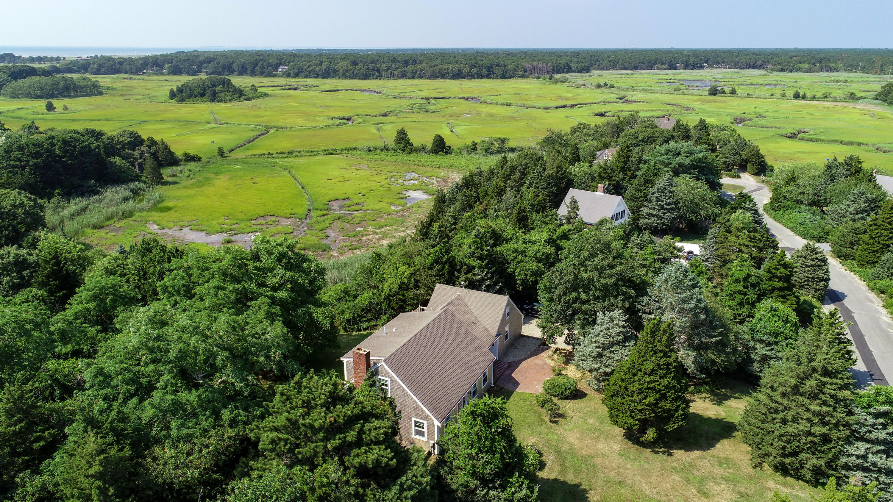 225 Goody Hallet Drive Eastham, MA 02642 - Photo 39 of 45 an aerial view of a house with a yard and lake view