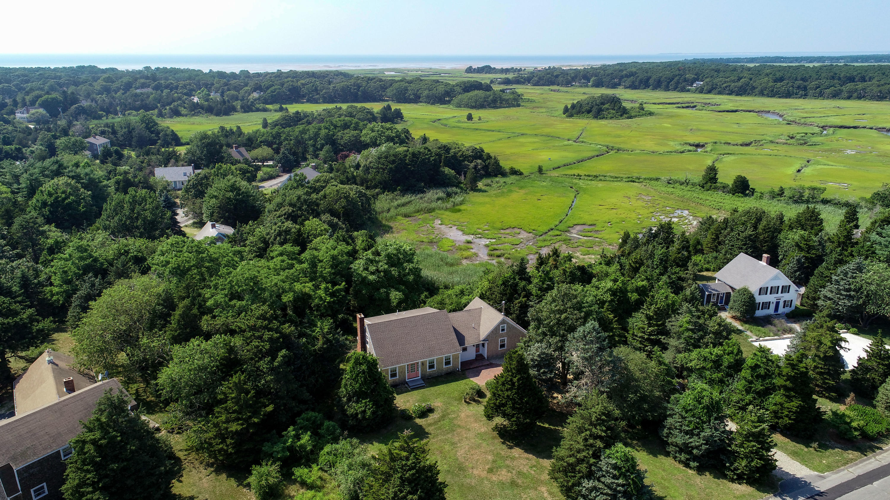225 Goody Hallet Drive Eastham, MA 02642 - Photo 41 of 45 an aerial view of green landscape with trees houses and lake view