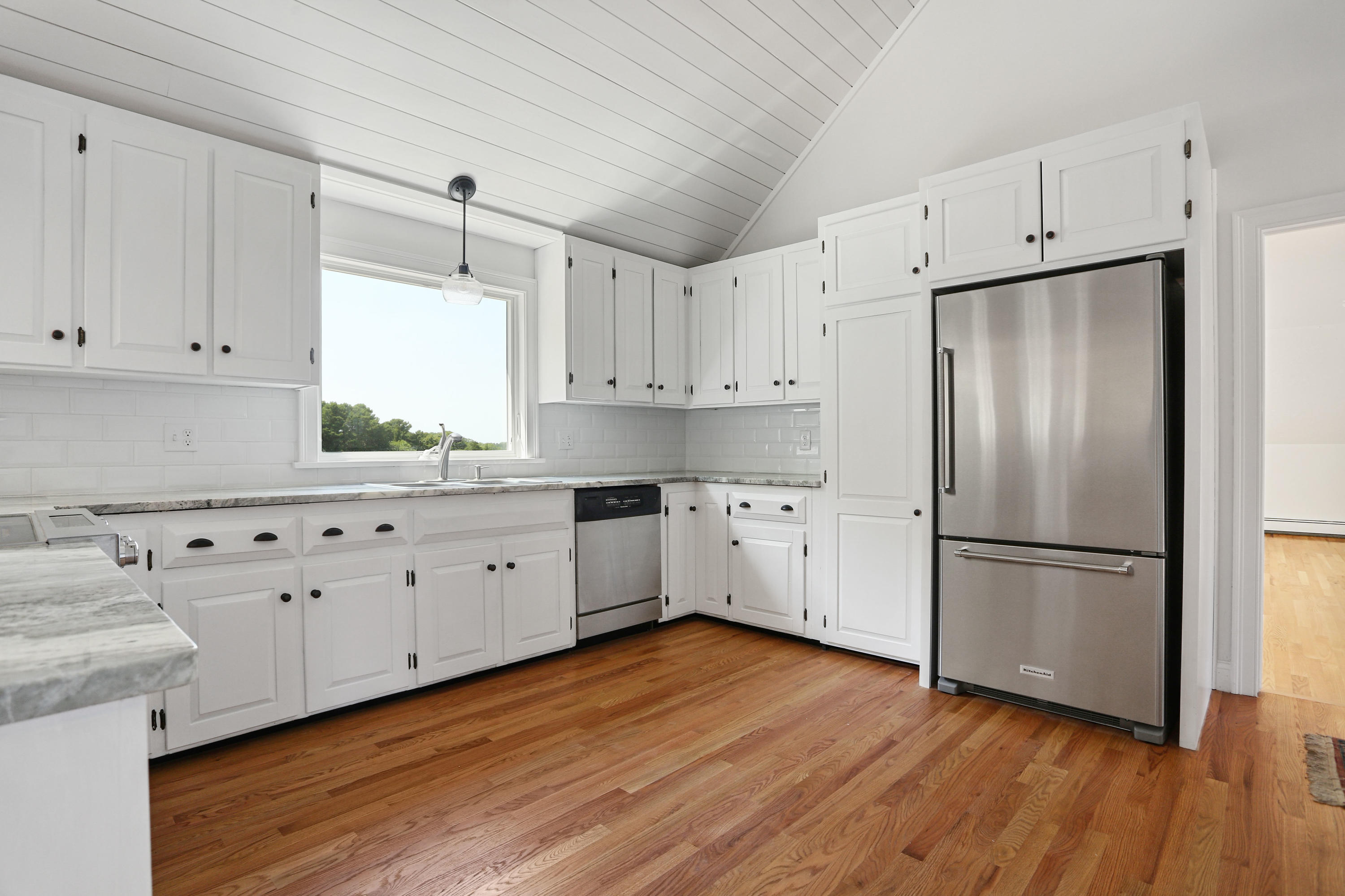 225 Goody Hallet Drive Eastham, MA 02642 - Photo 7 of 45 a kitchen with cabinets wooden floor and stainless steel appliances