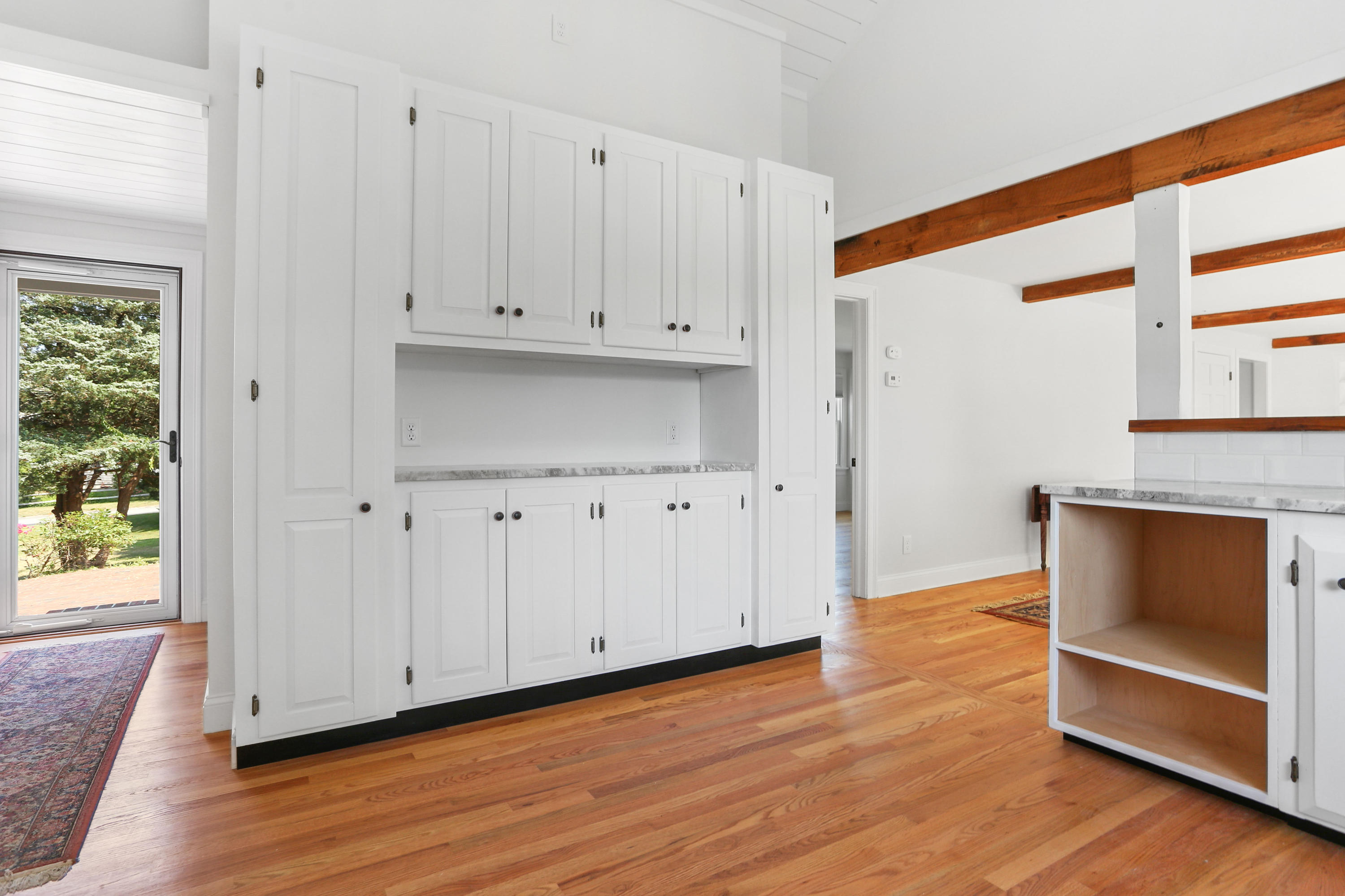 225 Goody Hallet Drive Eastham, MA 02642 - Photo 8 of 45 a view of an empty room with wooden floor and a window