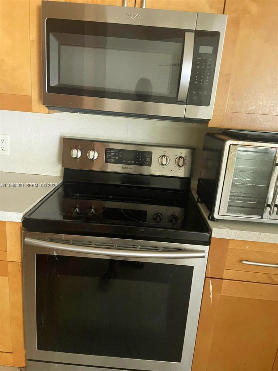 8821 Wiles Road, Unit 101 Coral Springs, FL 33067 - Photo 7 of 12 a stove top oven sitting inside of a kitchen