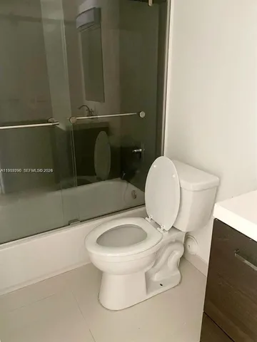 a bathroom with a toilet and a mirror