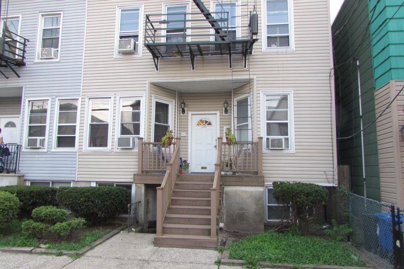 233 Griffith Street, Unit 2E Jersey City, NJ 07307 - Photo 12 of 12 a front view of a house with a yard