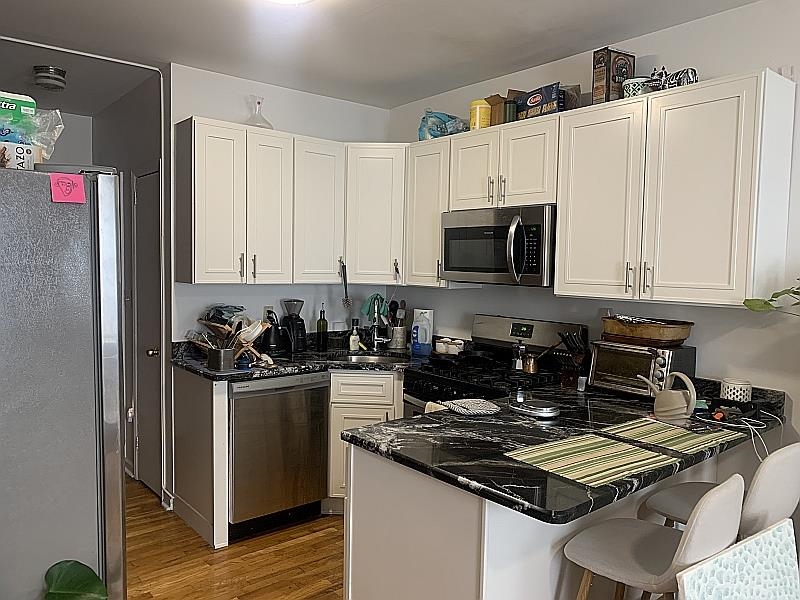 233 Griffith Street, Unit 2E Jersey City, NJ 07307 - Photo 2 of 12 a kitchen with a stove and a refrigerator