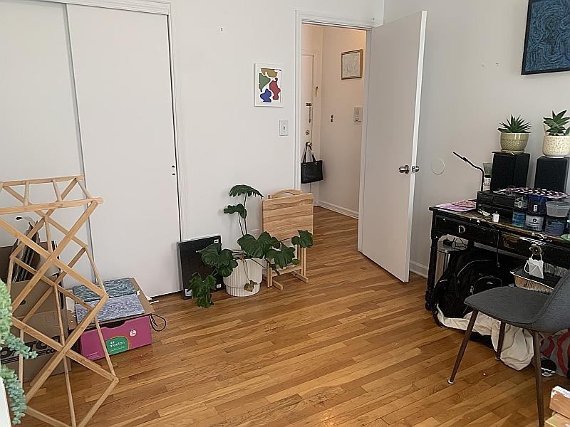 233 Griffith Street, Unit 2E Jersey City, NJ 07307 - Photo 7 of 12 a living room with furniture and wooden floor