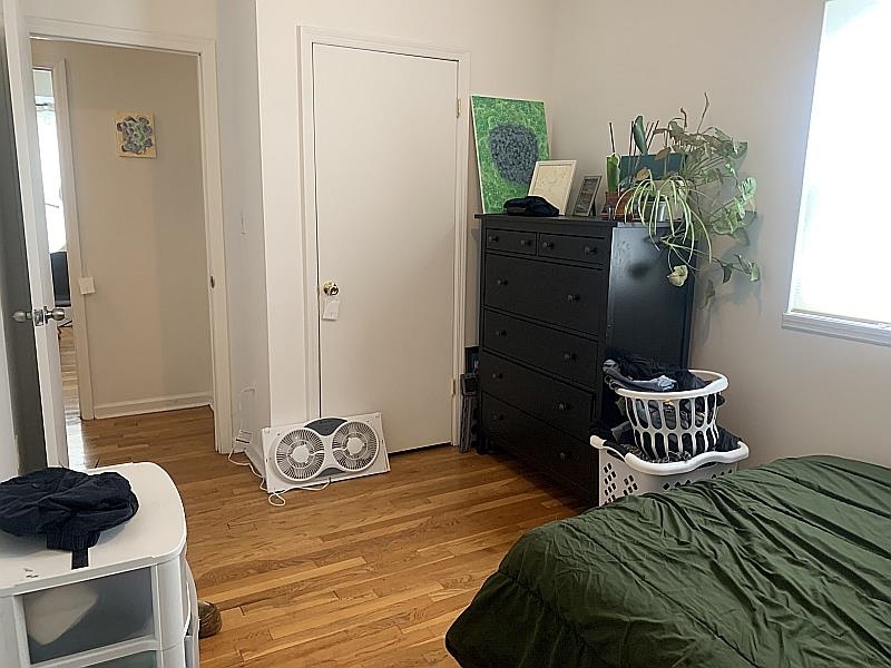 233 Griffith Street, Unit 2E Jersey City, NJ 07307 - Photo 9 of 12 a bedroom with a bed and dresser