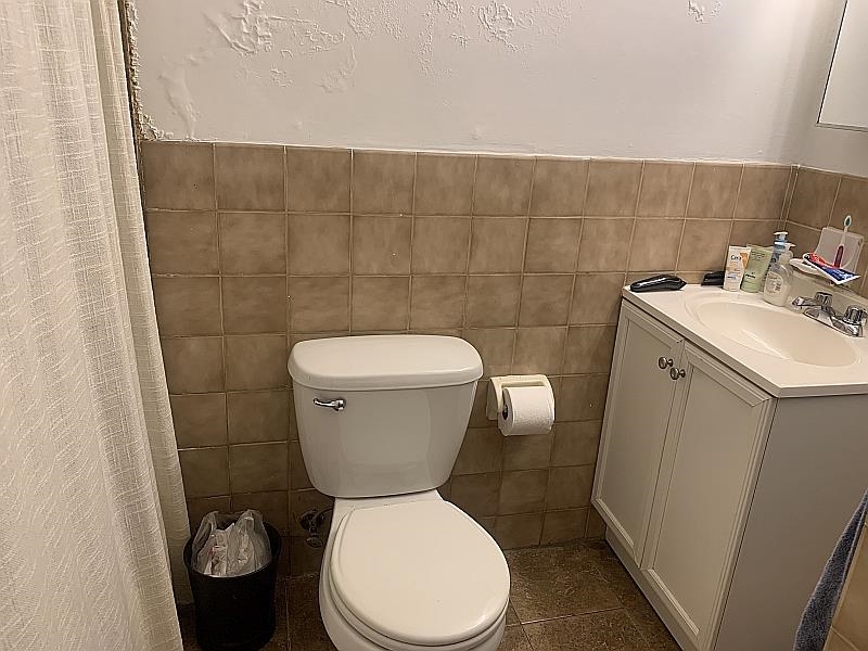 233 Griffith Street, Unit 2E Jersey City, NJ 07307 - Photo 10 of 12 a bathroom with a toilet sink and mirror