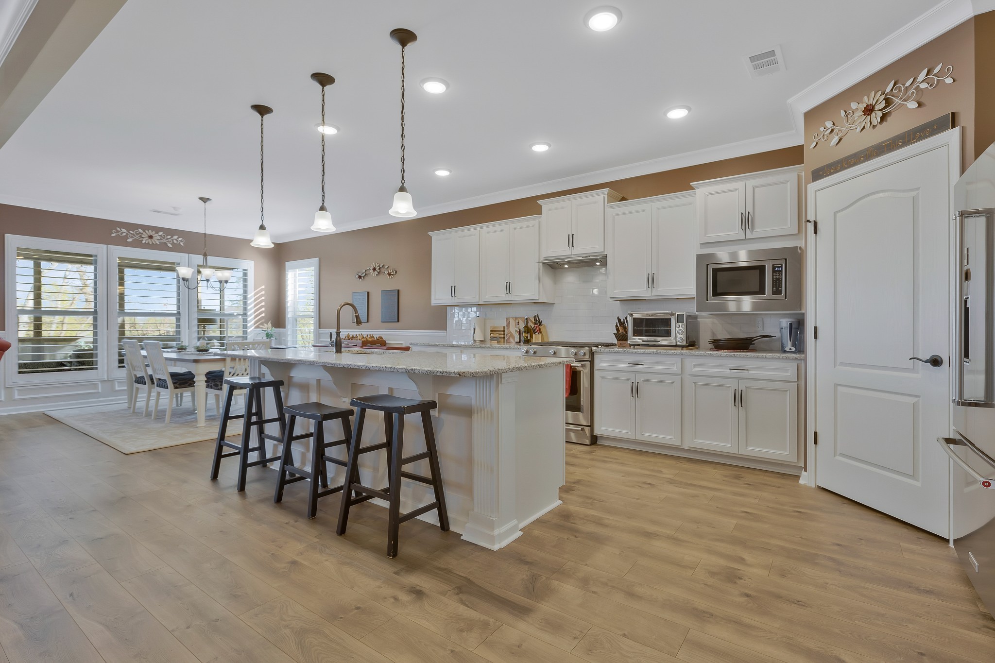 2132 Loudon Hill Spring Hill, TN 37174 - Photo 11 of 54 a kitchen with stainless steel appliances kitchen island granite countertop a stove a sink a refrigerator and white cabinets with wooden floor
