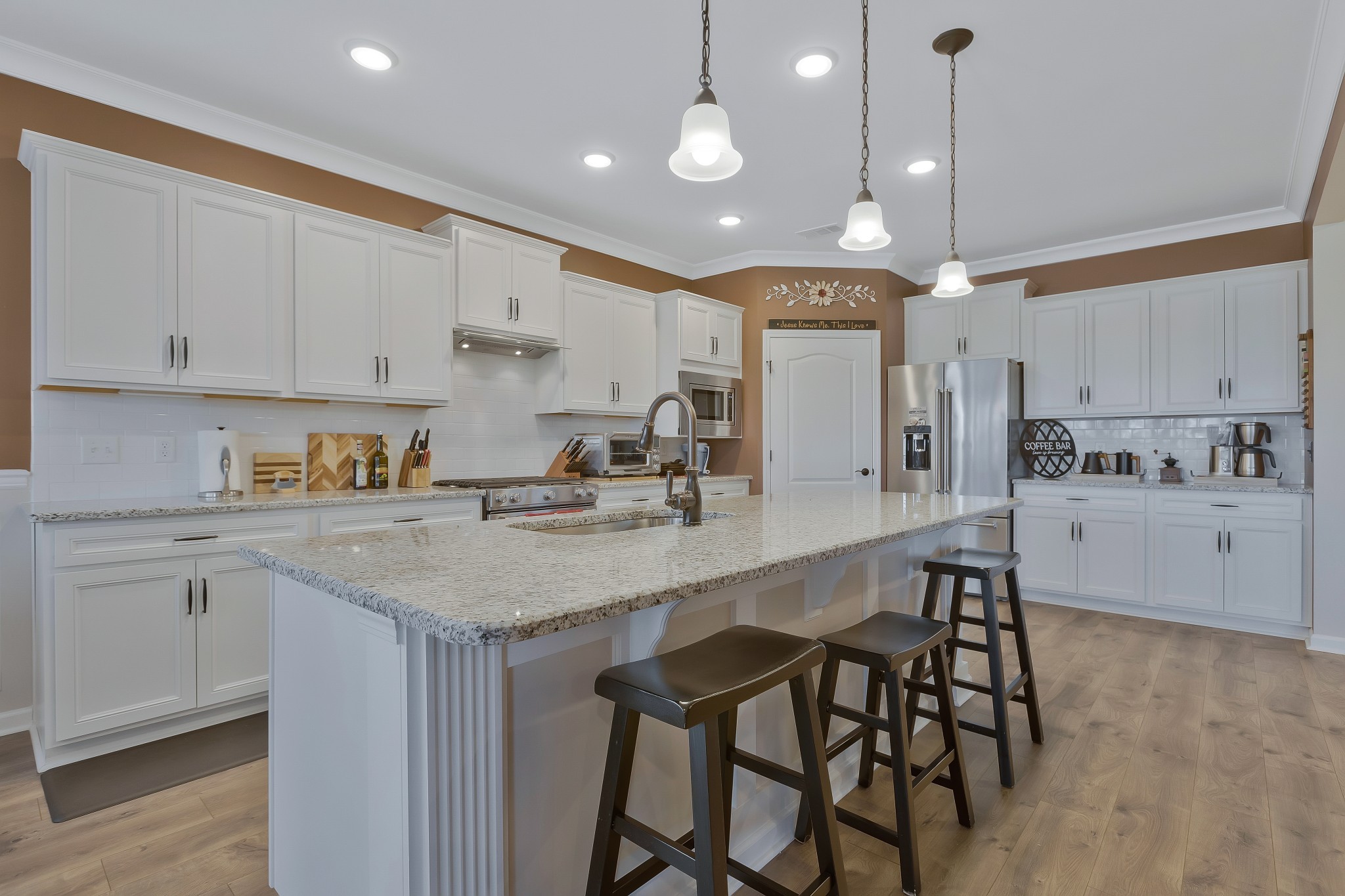 2132 Loudon Hill Spring Hill, TN 37174 - Photo 12 of 54 a kitchen with kitchen island granite countertop a sink a center island and cabinets