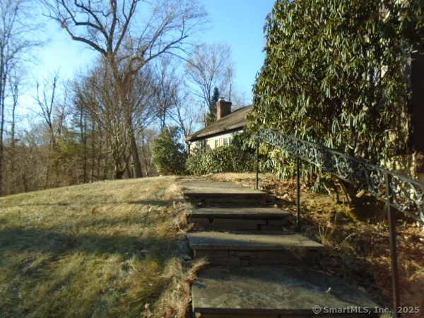 a view of backyard with wooden fence