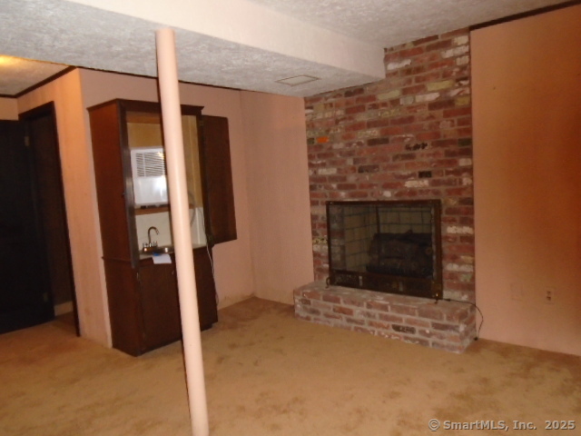 11 Timbercrest Drive Canton, CT 06019 - Photo 21 of 39 a view of an empty room with wooden floor and a fireplace