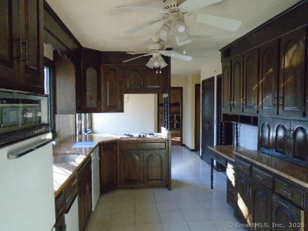 a kitchen with stainless steel appliances granite countertop a sink and cabinets