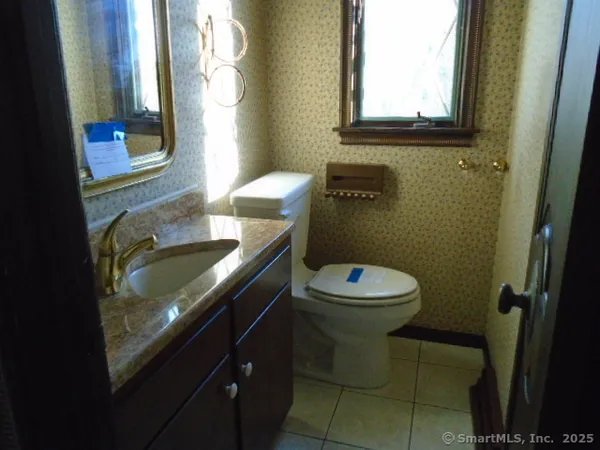 a bathroom with a toilet sink and mirror
