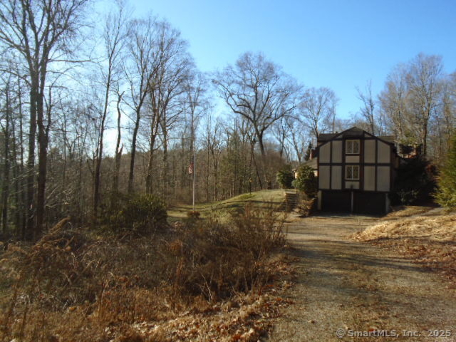 11 Timbercrest Drive Canton, CT 06019 - Photo 3 of 39 a view of a yard covered with snow in the background