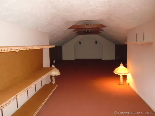 a view of entryway and hall with a chair