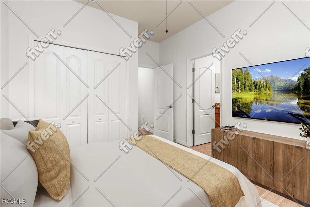 16471 Windsor Way Alva, FL 33920 - Photo 15 of 23 a bedroom with a bed and a flat tv screen on the dresser