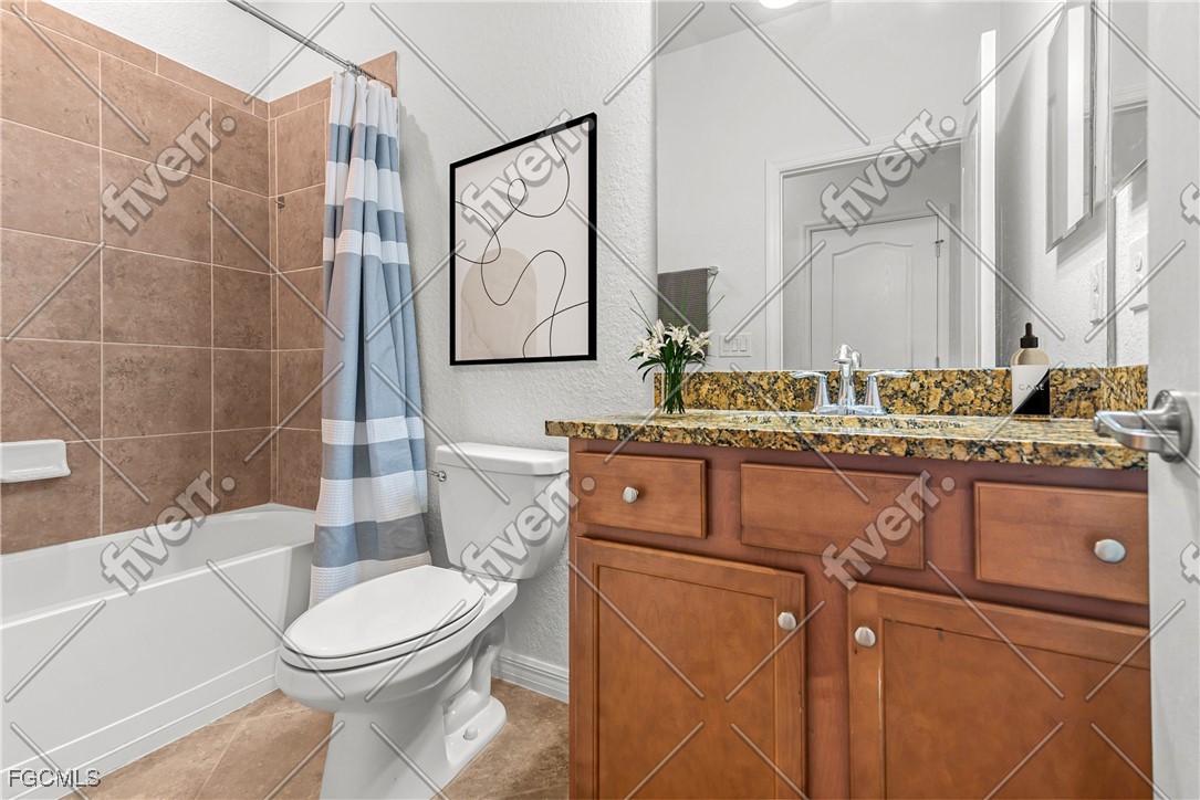 16471 Windsor Way Alva, FL 33920 - Photo 19 of 23 a bathroom with a toilet sink and mirror