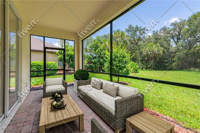 a living room with patio furniture and garden