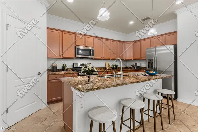 a kitchen with stainless steel appliances granite countertop a sink a stove a refrigerator cabinets and dining table