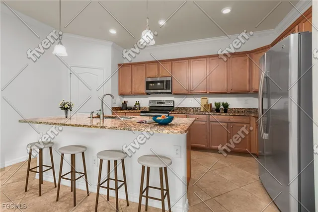 a kitchen with cabinets a sink stainless steel appliances and a window